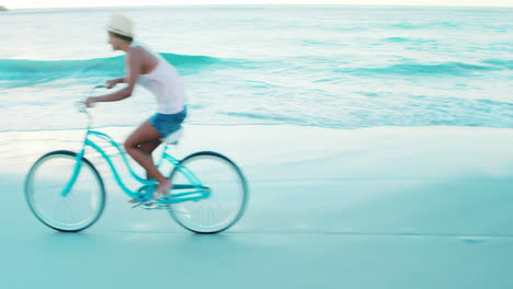 Beautiful-woman-cycling-on-the-beach