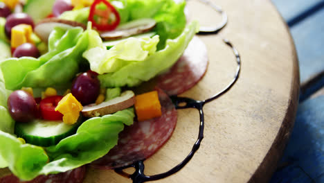 Salad-decorated-on-wooden-plate