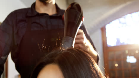 Woman-getting-his-hair-dried-with-hair-dryer