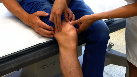 Ärztin-Untersucht-Knie-Des-Patienten