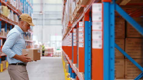 Warehouse-worker-keeping-package-in-shelf