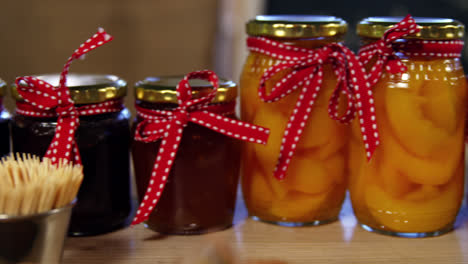 Jars-of-pestos,-jam-and-preserves-on-display-counter
