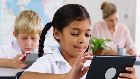 School-kids-using-digital-tablet-in-classroom