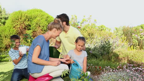 Happy-young-family-gardening-together