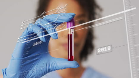 Animation-of-data-processing-and-connections-over-biracial-female-doctor-with-vial