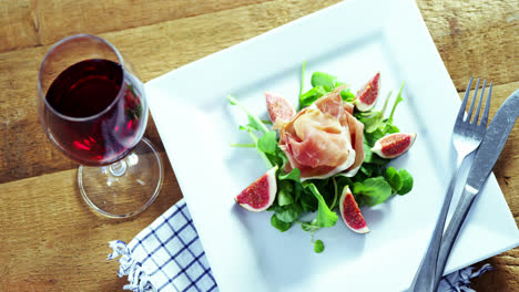 Salad-with-red-wine-on-wooden-table