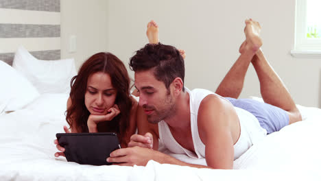 Happy-couple-using-tablet-together