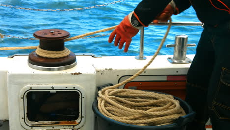 Fisherman-tying-rope-on-bollard