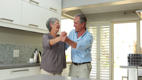 Senior-couple-smiling-and-dancing