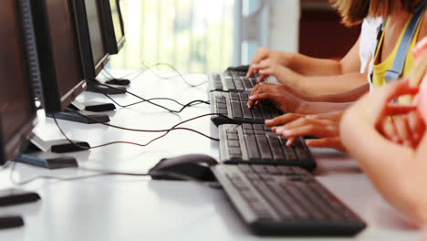 Schoolgirls-using-computer-in-classroom