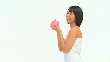Lovely-asian-lady-saving-up-money-in-a-piggy-bank