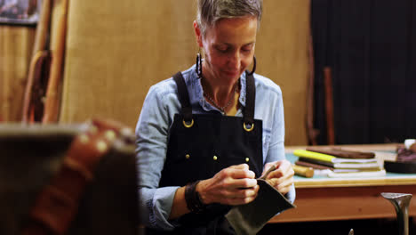 Craftswoman-working-on-a-piece-of-leather