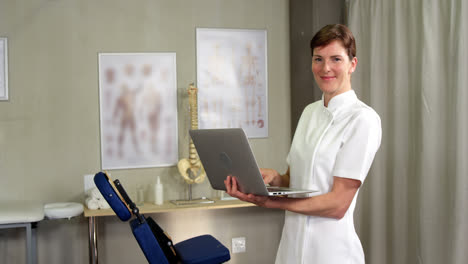 Female-physiotherapist-using-laptop