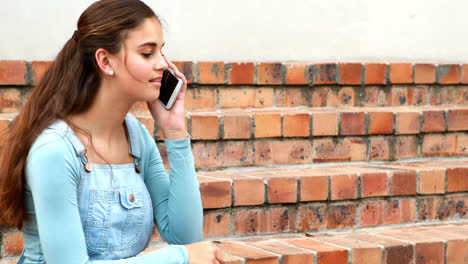 Happy-schoolgirl-talking-on-mobile-phone