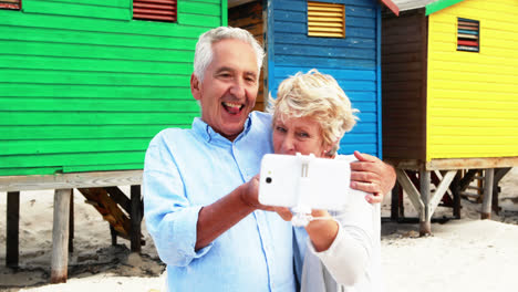 Senior-couple-taking-a-selfie-on-the-beach