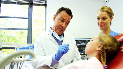 Dentist-interacting-with-young-patient