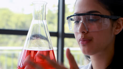 Attentive-schoolgirl-doing-a-chemical-experiment-in-laboratory