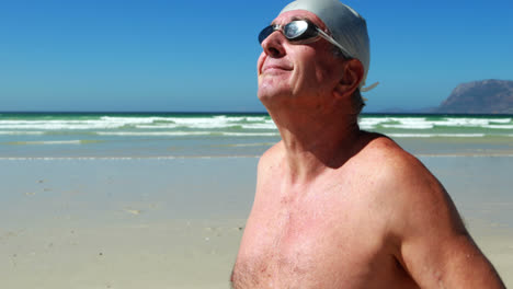 Senior-man-wearing-swim-goggle-at-the-beach