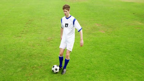 Football-player-kicking-a-ball-in-the-field