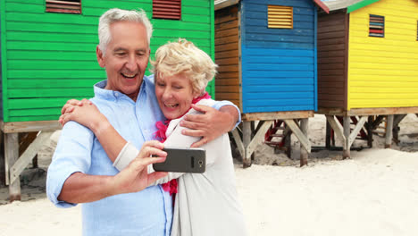 Senior-couple-taking-a-selfie-on-the-beach