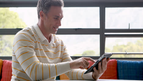 Male-teacher-using-digital-tablet