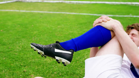 Injured-football-player-lying-on-grass