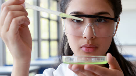 Attentive-schoolgirl-experimenting-in-laboratory