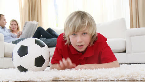 Kid-watching-a-football-match-in-television-on-floor