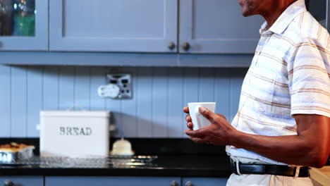 Senior-man-having-coffee-in-kitchen