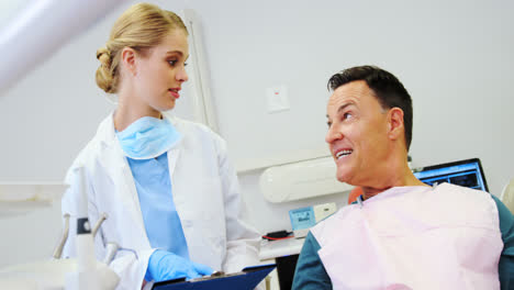 Dentist-interacting-with-a-male-patient