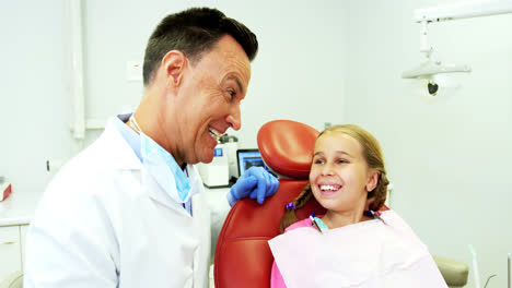 Dentist-examining-a-young-patient-with-tools