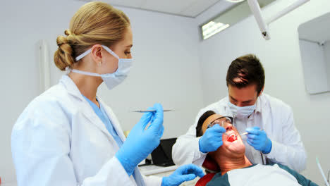 Dentists-giving-anesthesia-to-male-patient