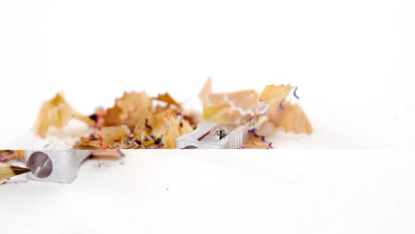 Colored-shavings-with-brown-color-pencil-and-sharpener-in-saucer