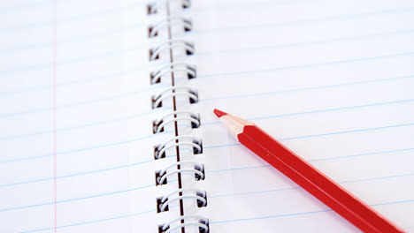 Red-color-pencil-kept-on-the-book