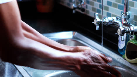 Close-up-of-senior-man-washing-hands