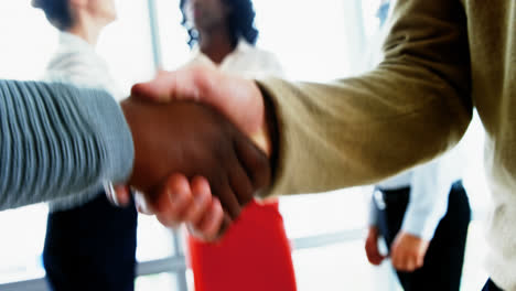 Executives-shaking-hands-in-office