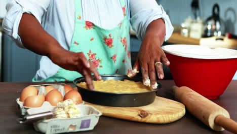 Senior-woman-preparing-sweet-food-in-kitchen