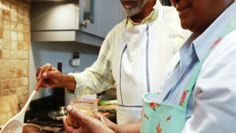 Senior-couple-preparing-food-in-kitchen