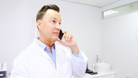Dentist-talking-on-mobile-phone