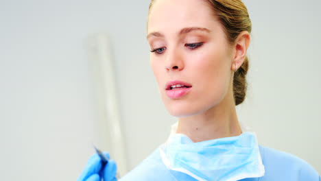 Female-nurse-holding-a-dental-tool