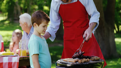 Father-and-son-preparing-food-on-barbecue