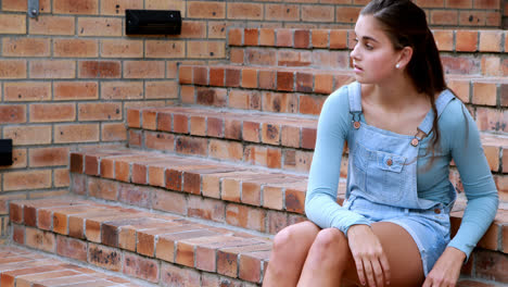 Sad-schoolgirl-sitting-alone-on-staircase