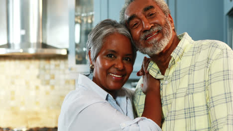 Senior-couple-standing-in-kitchen