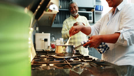 Senior-couple-preparing-food-in-kitchen