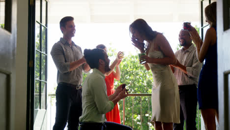 Man-proposing-woman-with-ring-by-kneeling-down