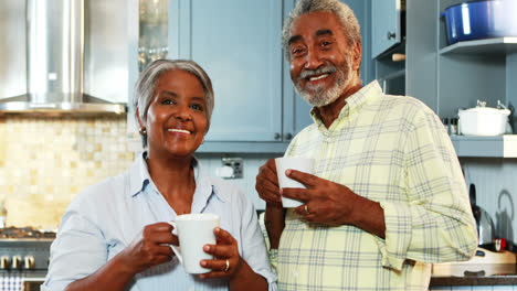 Senior-couple-having-coffee-in-kitchen