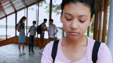 School-friends-bullying-a-sad-girl-in-corridor
