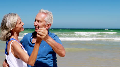 Senior-couple-having-ice-cream-at-the-beach
