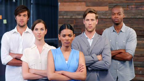 Portrait-of-business-executives-standing-with-arms-crossed