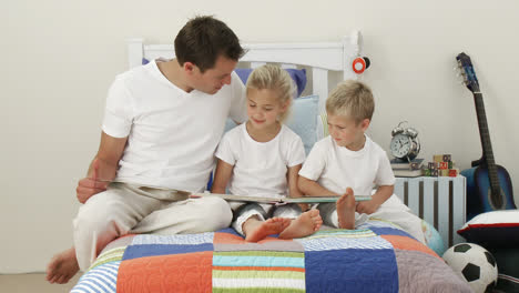 Father-reading-with-his-children-in-the-bedroom